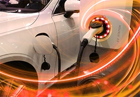 White electric vehicle being charged.