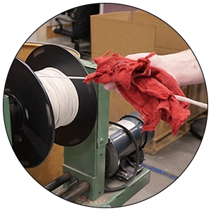 Re-spooling Person handling cable on a re-spooling machine.