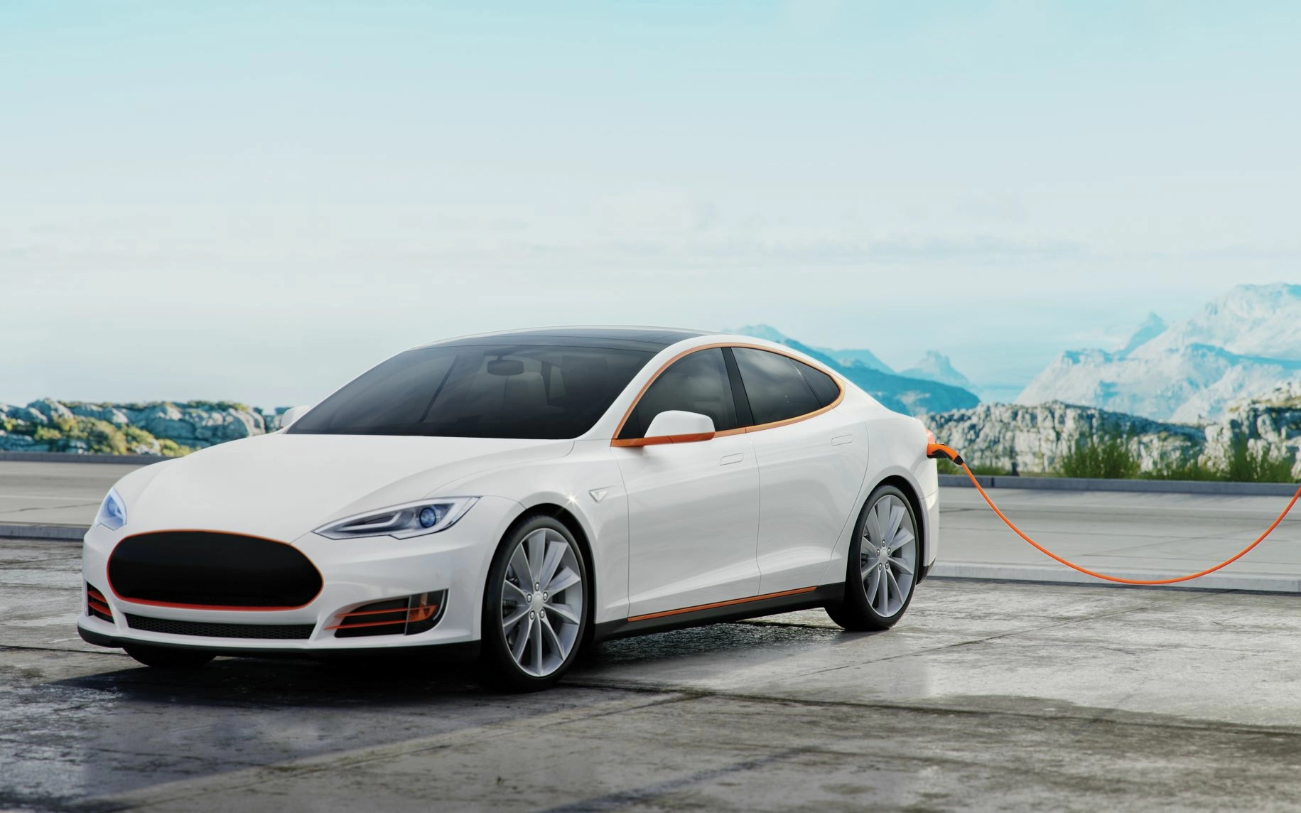 White electric vehicle plugged into a charging station with mountains in the background.