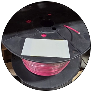 Custom Labeling Red cable on a black spool with a custom label.